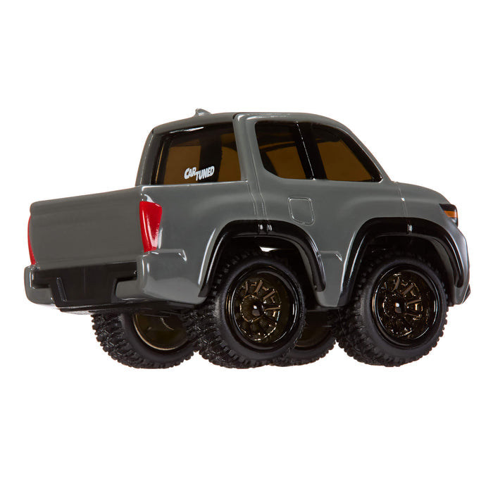 Model truck with large wheels on a white background