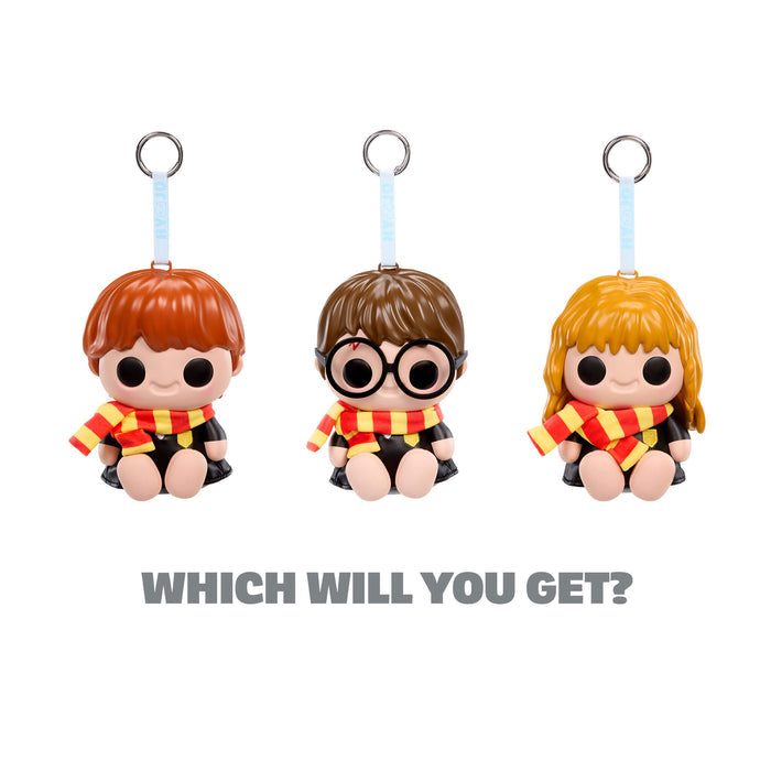Three keychains of cartoon characters with red and yellow scarves on a white background.