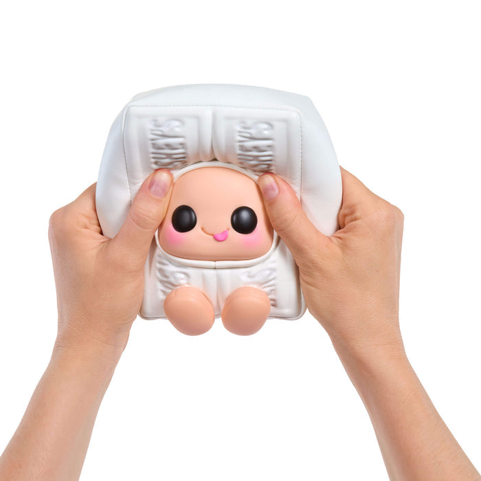 Squishy toy resembling a White Hershey's bar held by two hands on a white background