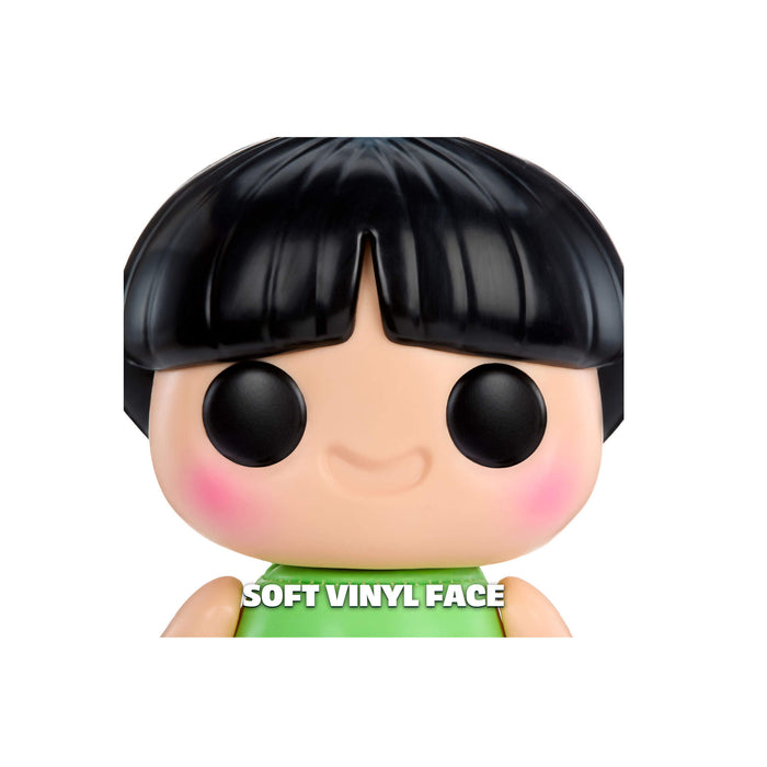Toy figure with black hair and green shirt on a white background