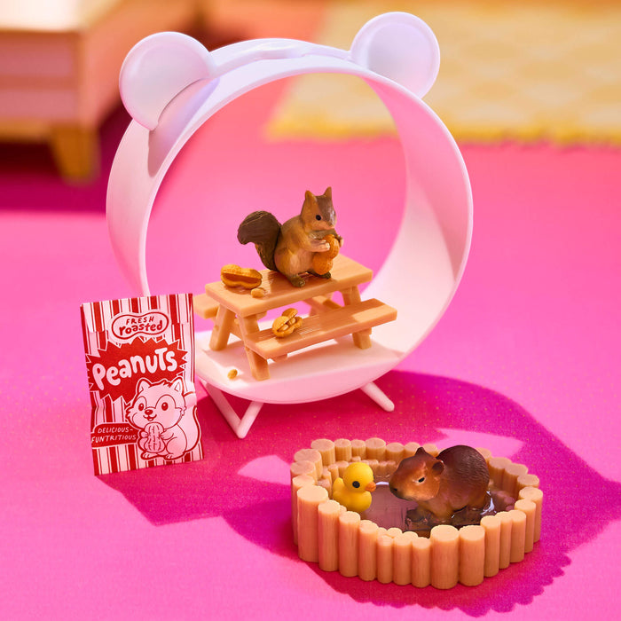 Miniature squirrel figurine on a small table with a pink background
