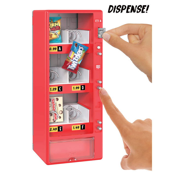 Red toy vending machine with snacks and a hand pressing the 'Dispense!' button.