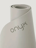 Grey yoga mat with 'Onyx' branding